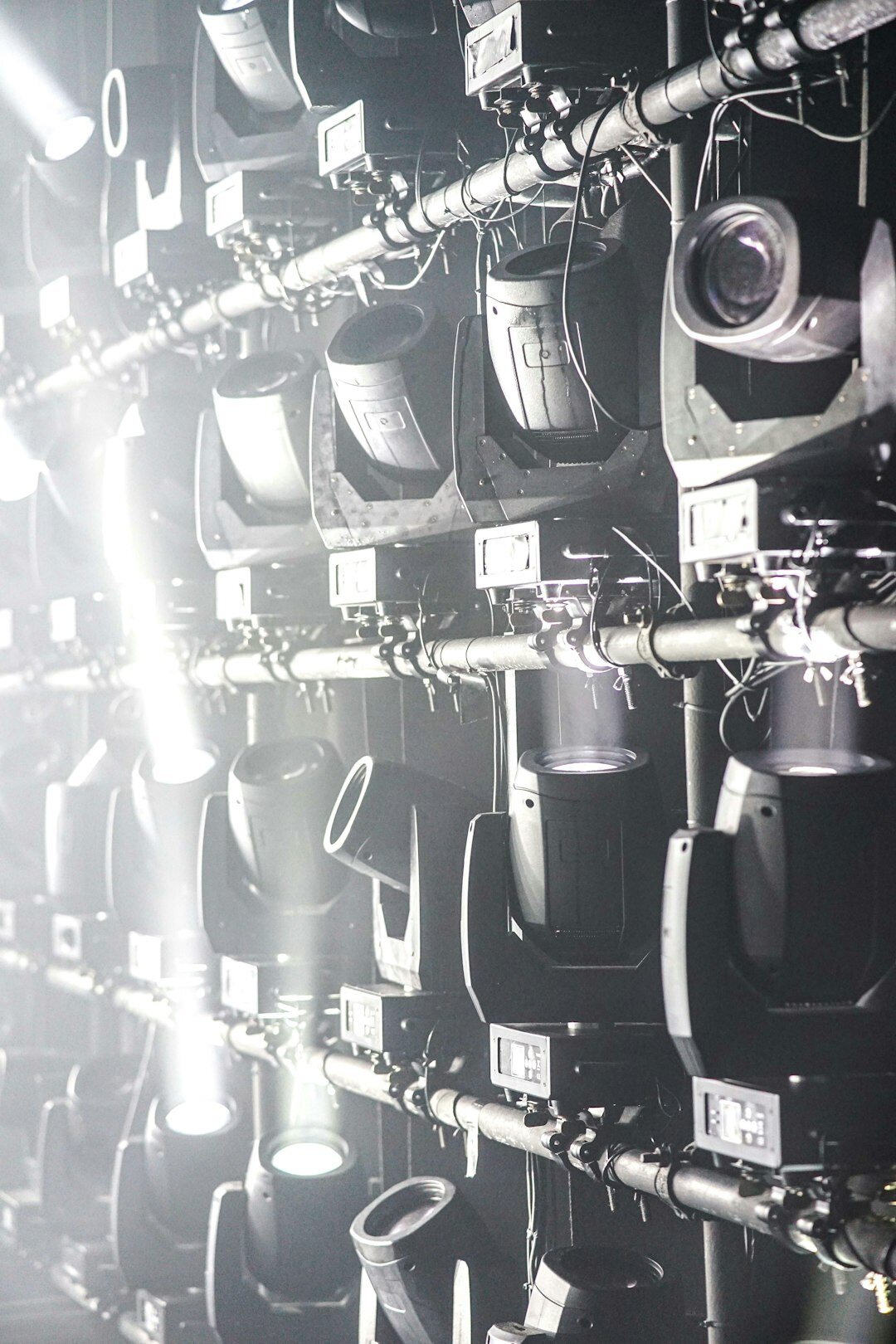 Wall of broadcast monitors displaying live camera feeds